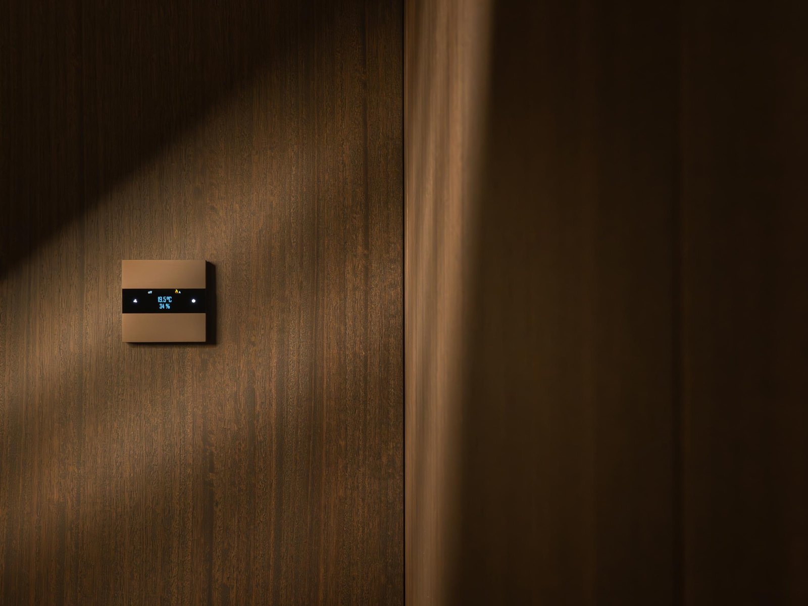 Basalte minimalist Belgian touch switch on a plaster wall