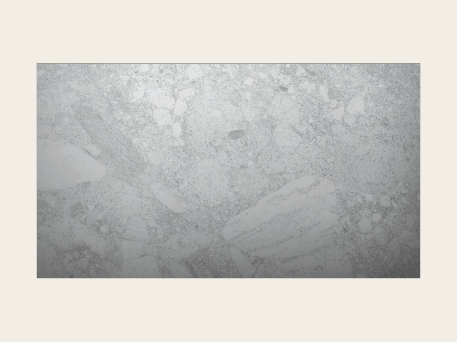 Black Nova Italian glass-face touch keypad on a limestone wall