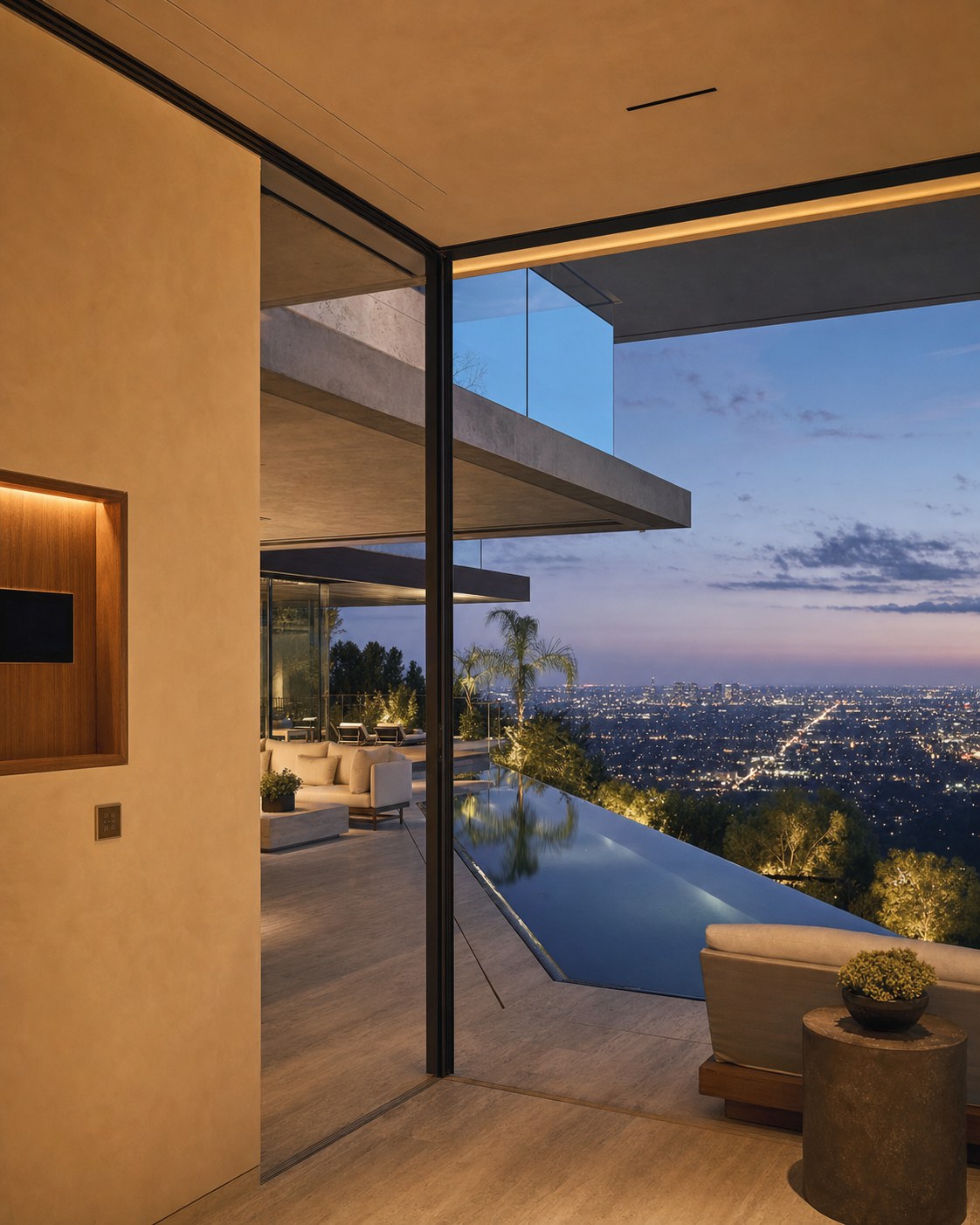 Bel Air hillside modern estate at dusk overlooking the Los Angeles city grid — concealed technology in stone and steel architecture