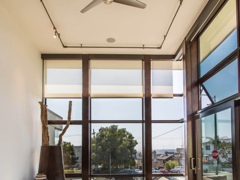 MDS 25 A room with large windows and a ceiling fan.